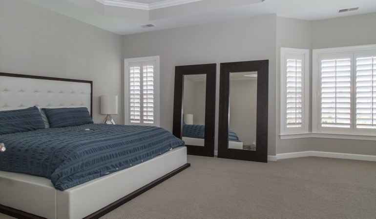 Polywood shutters in a minimalist bedroom in Detroit.